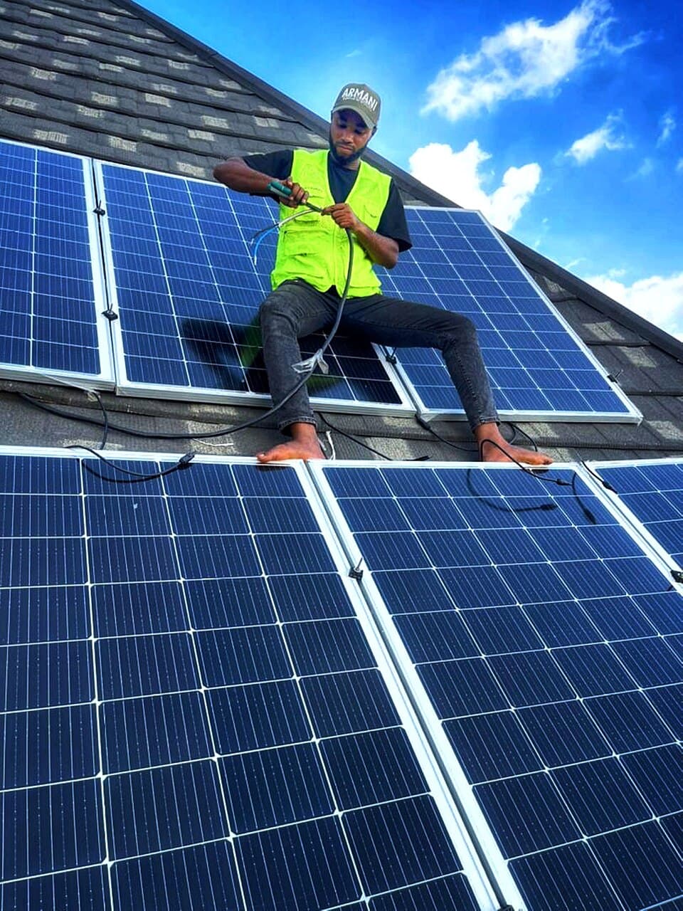 Technician installing solar panels in Nigeria